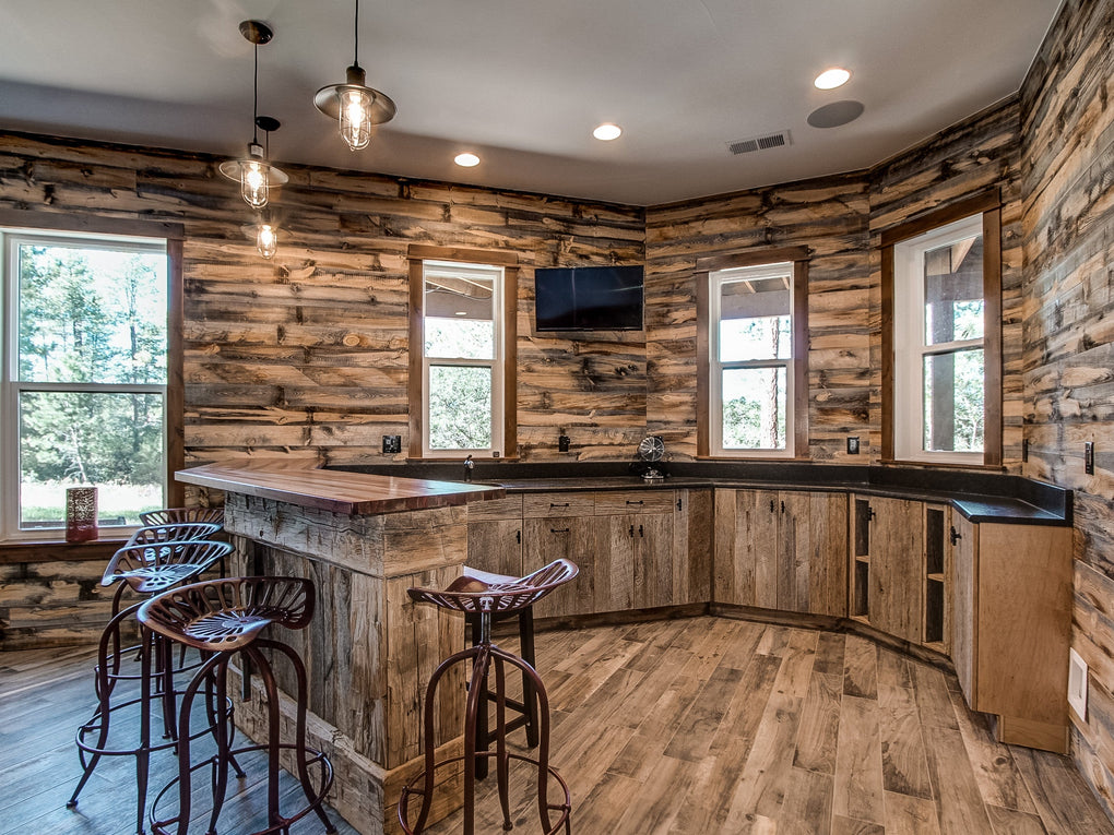Rustic wood wall in a kitchen by Eagles Nest Developers using Centennial Woods reclaimed wood boards