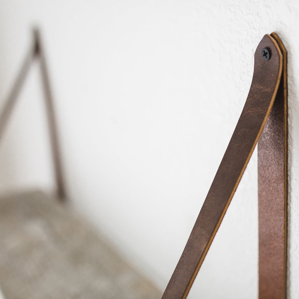 Close up of leather straps for reclaimed wood wall shelves by Range Leather in Laramie, WY