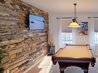 Home billiards room with a reclaimed wood feature wall