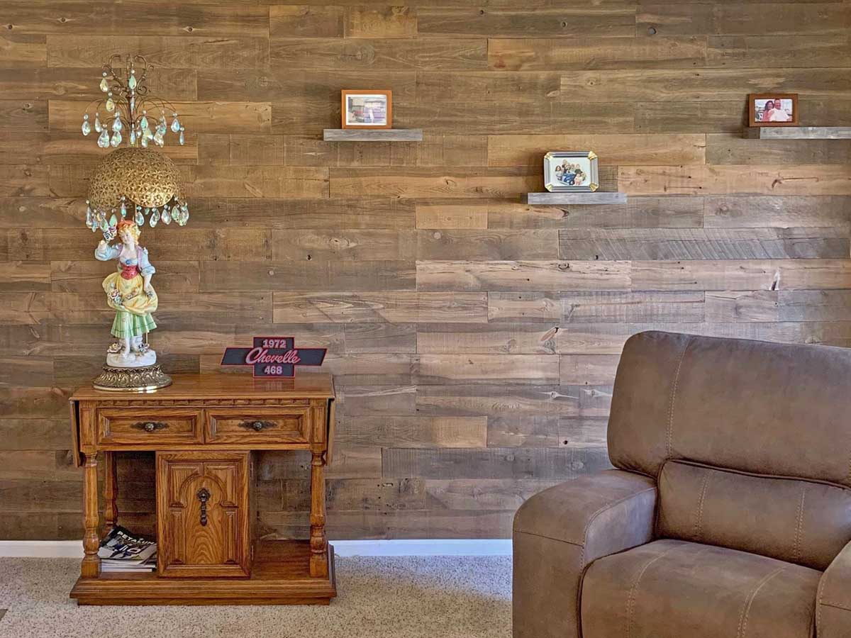 Reclaimed wood wall in a living room using the Saratoga planks from Centennial Woods. Accent wall installed by sons for their mother Karen