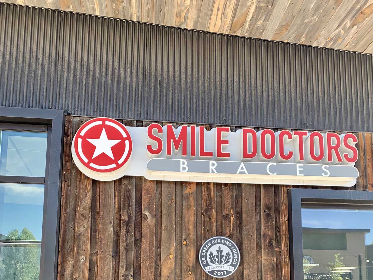 Reclaimed wood board-on-board siding and reclaimed wood soffit on a Smile Doctors in Summit County Colorado USGBC LEED certified
