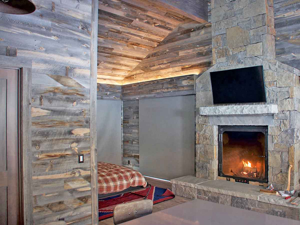 reclaimed wood wall in gray tones in a traditional style bedroom with a quilted bed spread.
