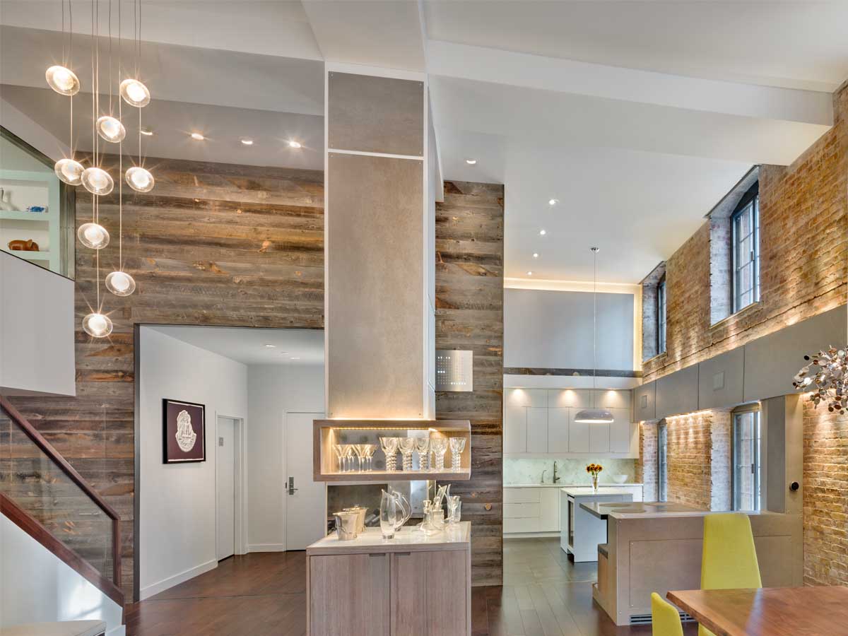NYC loft with a reclaimed wood accent wall from Centennial Woods by Rodriguez Architecture
