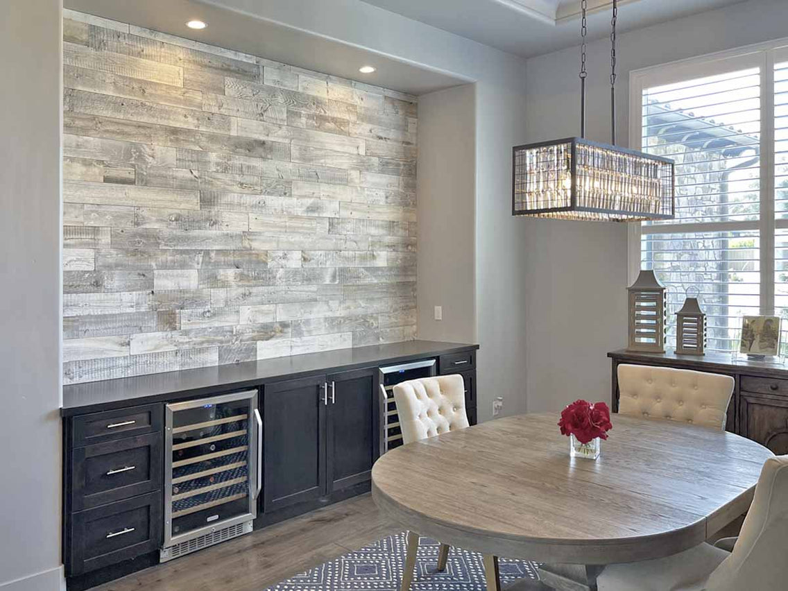White wash reclaimed wood accent wall in a transitional dining room.